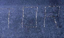 Photograph of vector marking on a piece of steel.